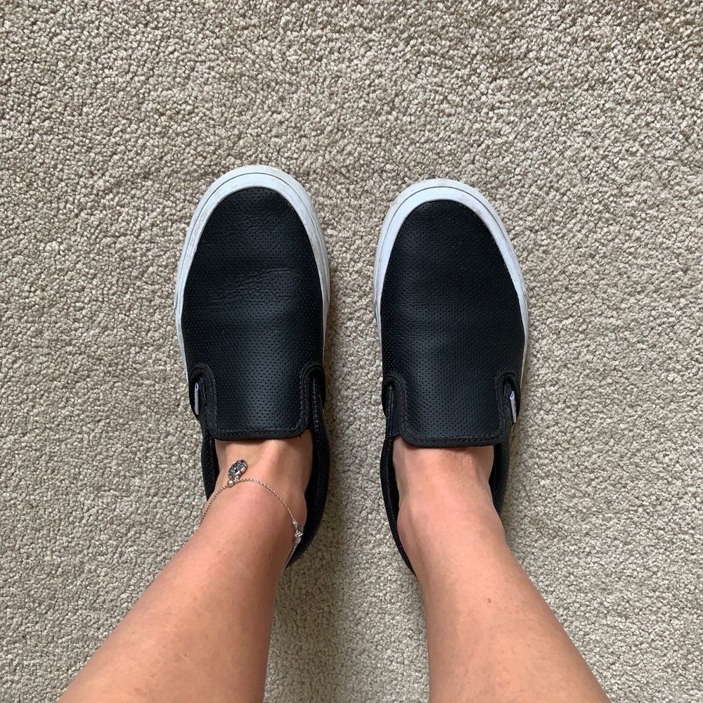 Black slip on Vans sneakers